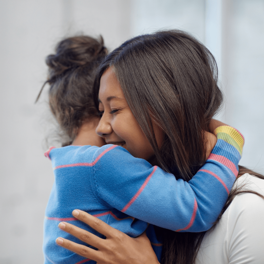 Woman hugging child